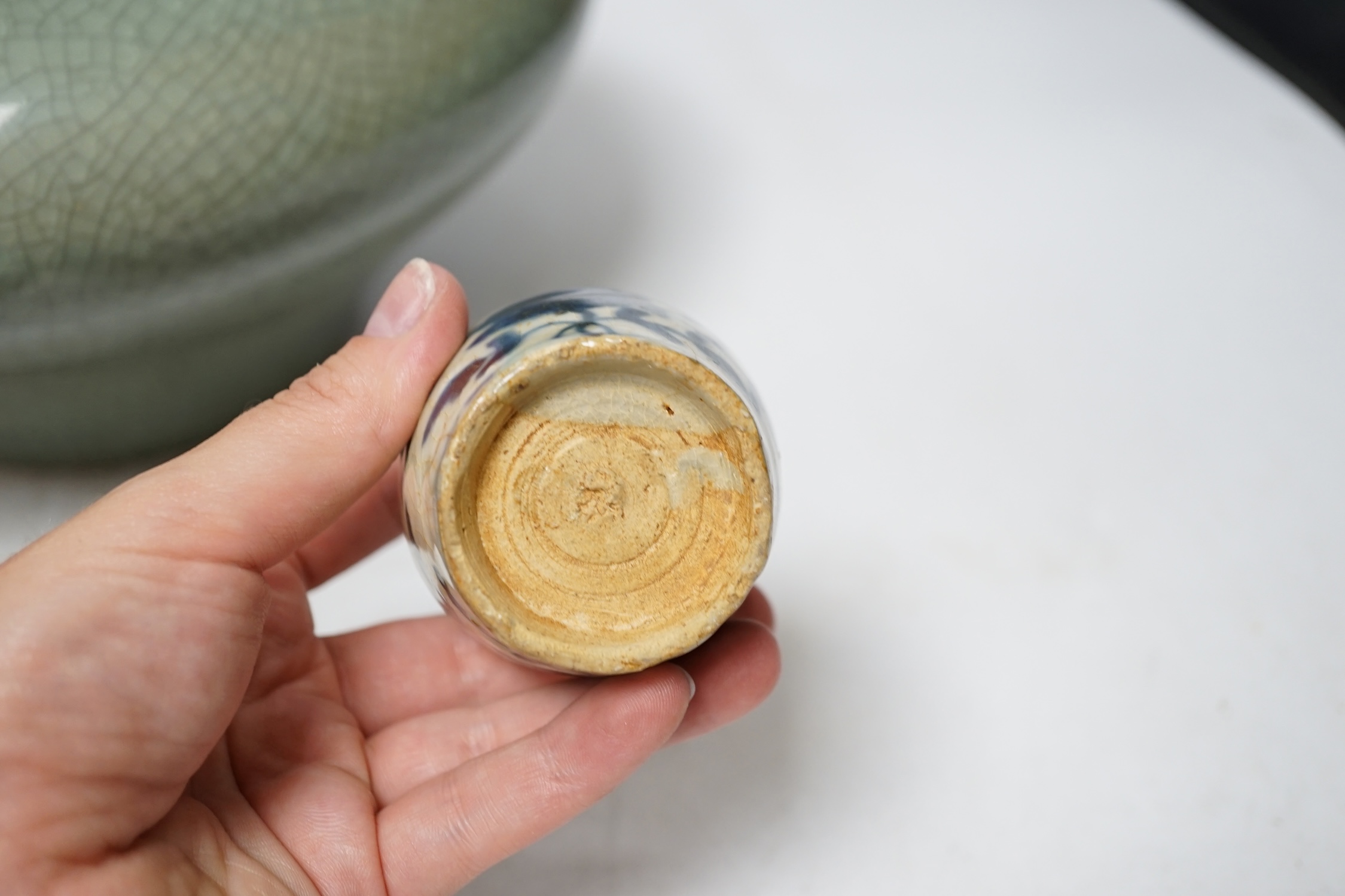 Three pieces of Asian pottery items comprising a Japanese blue and white dish, a green crackleware squat vase and an early 17th century Swatow jarlet, largest 18cm high. Condition - fair